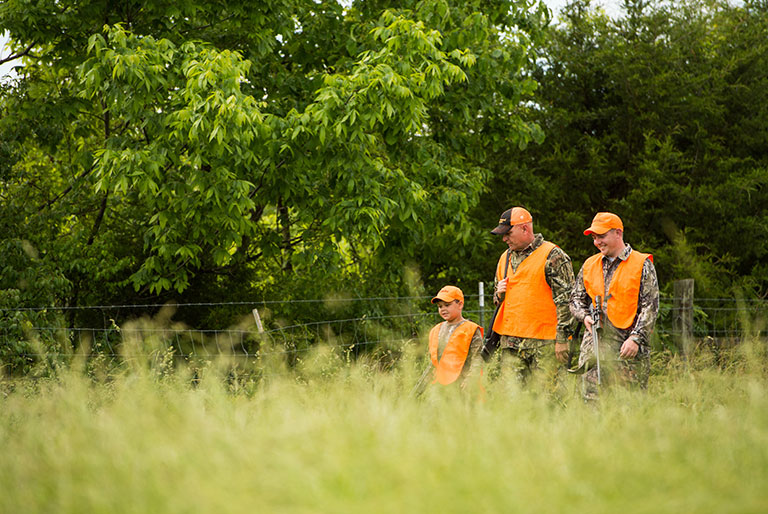 three hunters in orange